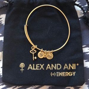 Alex and Ani gold bracelet with a key charm